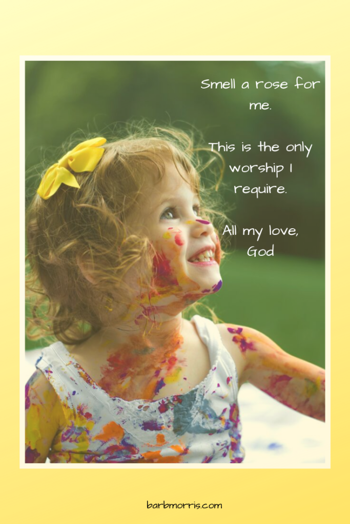 Smell a rose for me. This is the only worship I require. All my love, God. (Photo of paint-covered smiling girl.)