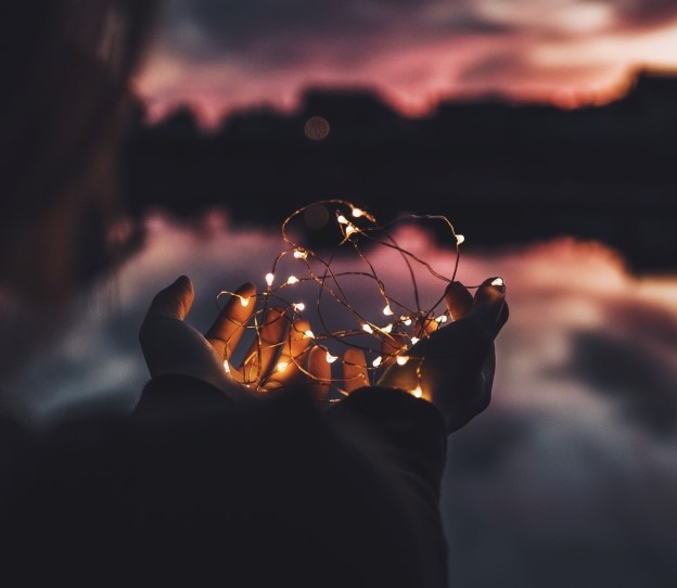 Woman holding a string of Christmas lights