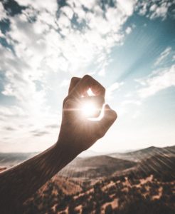 Sun shining through fingers