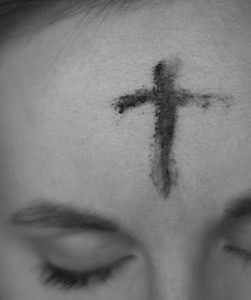 Woman with a cross of ashes on her forehead
