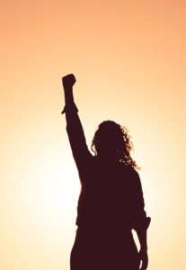 Woman raising fist in triumph